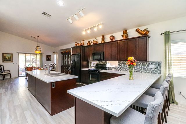 There is a large island in the middle of the kitchen.