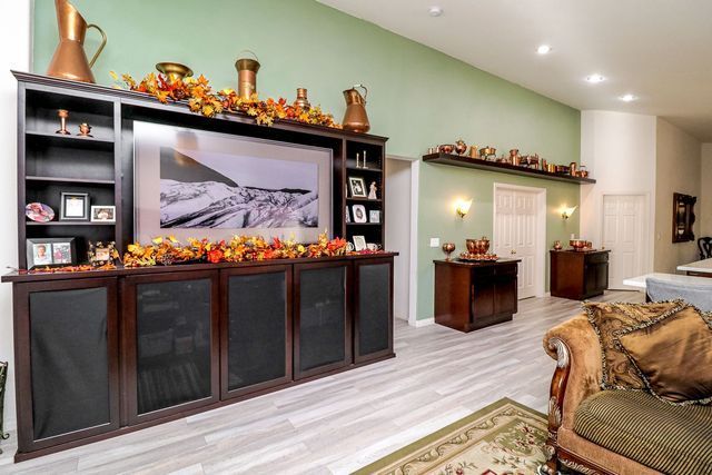 A living room with a large flat screen tv on the wall.