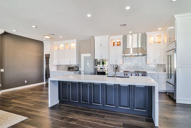 There is a large island in the middle of the kitchen.