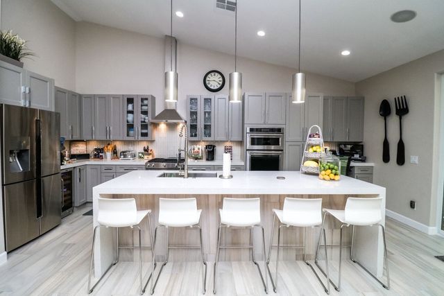 A kitchen with stainless steel appliances and a large island