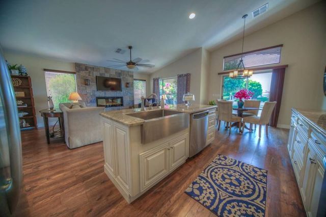 A kitchen in a house with a large island and a sink.