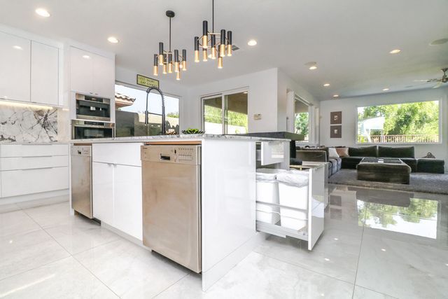 A kitchen with a large island and stainless steel appliances.