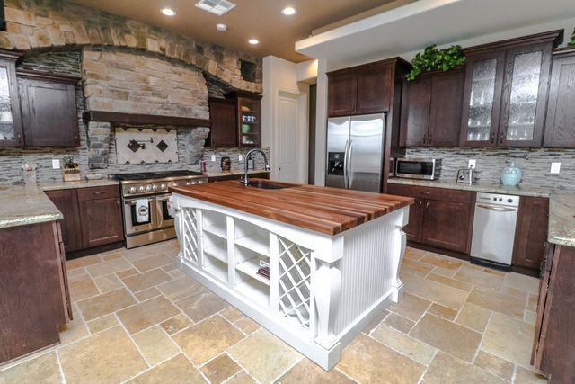 There is a large island in the middle of the kitchen.