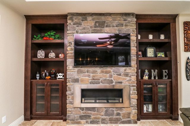 A living room with a fireplace and a flat screen tv.
