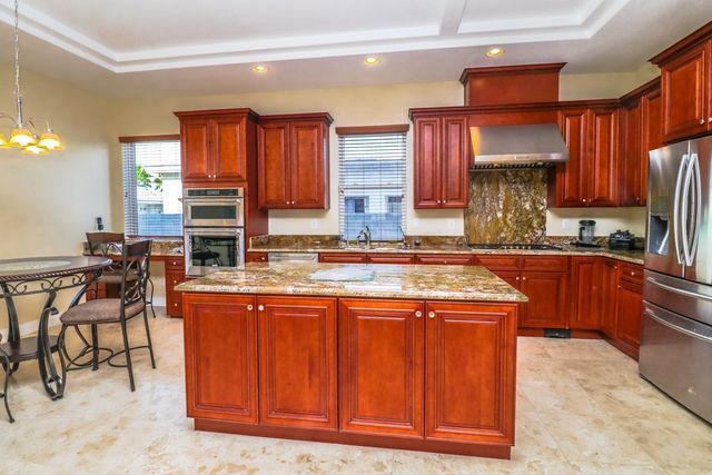 A kitchen with stainless steel appliances and wooden cabinets