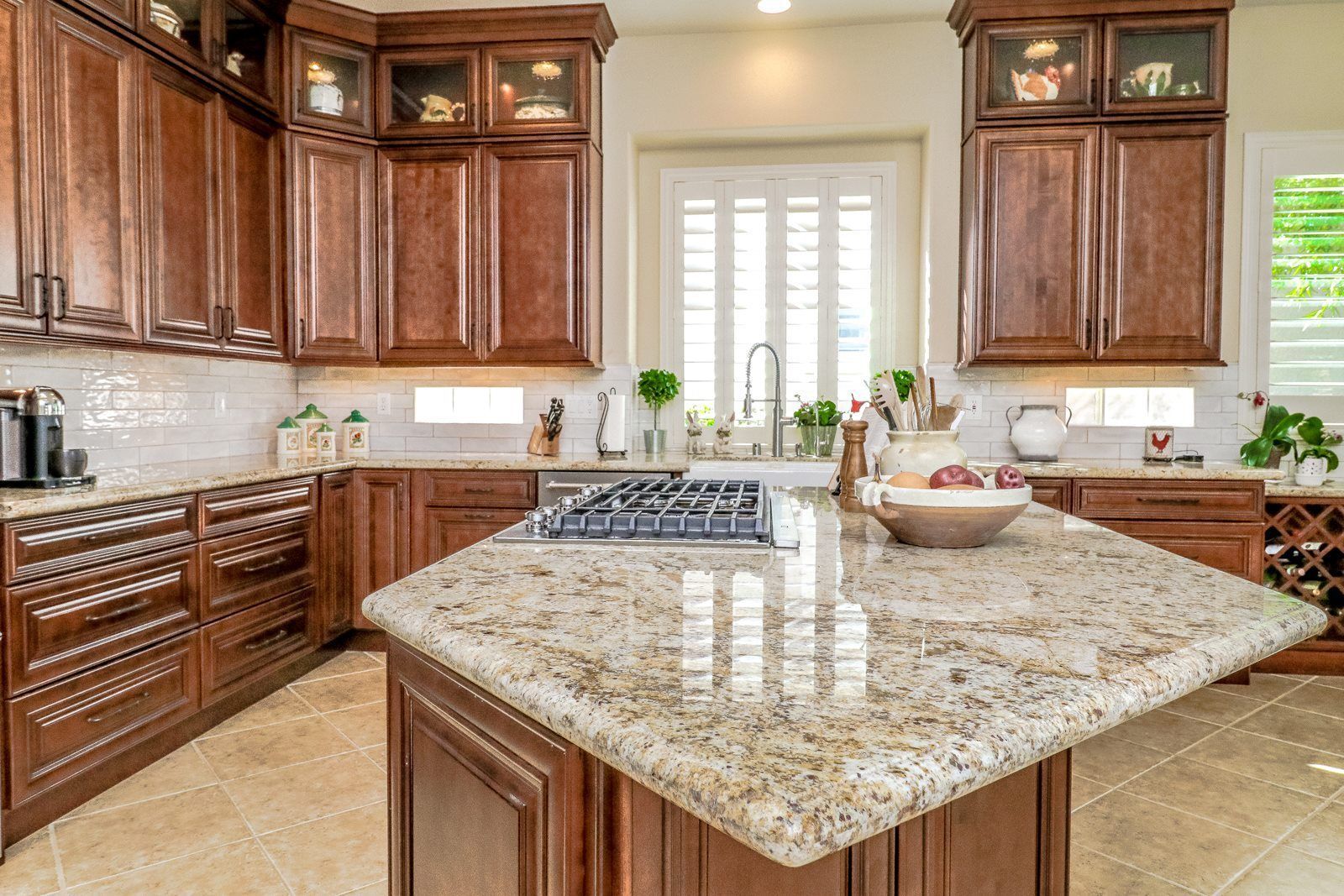 Contemporary dark kitchen with custom cabinetry and quartz waterfall island, Henderson NV