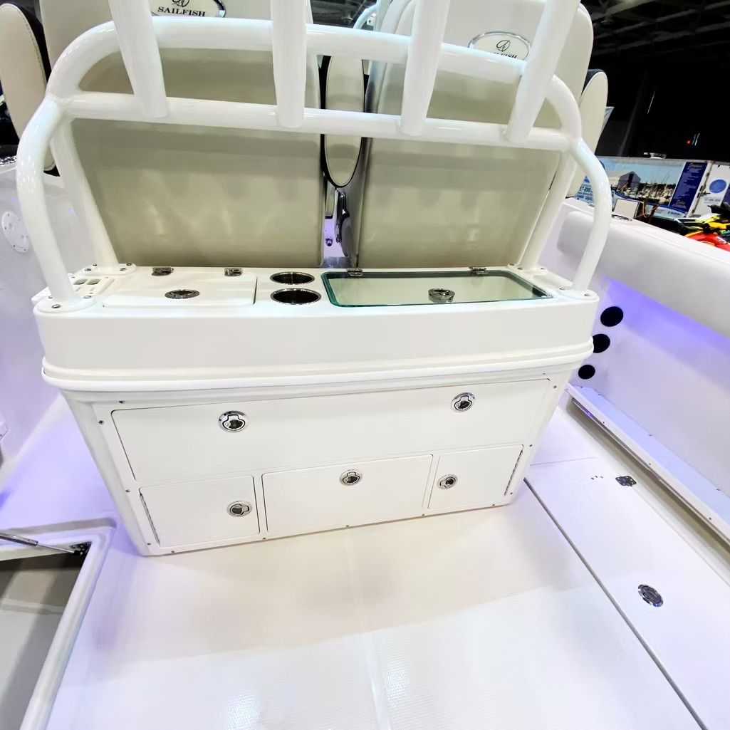 White boat storage unit with seats and cup holders, on a boat.