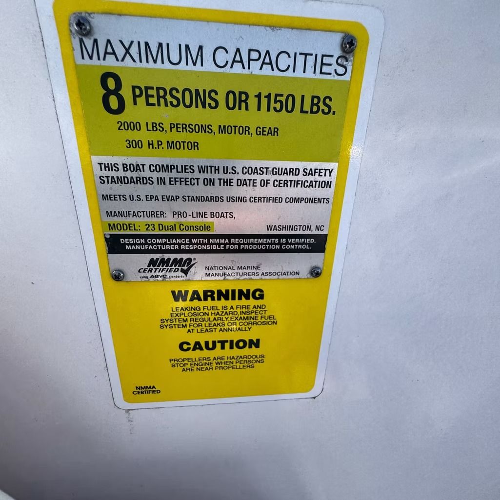 Yellow and black boat capacity label: 8 persons or 1150 lbs. Warnings and caution.