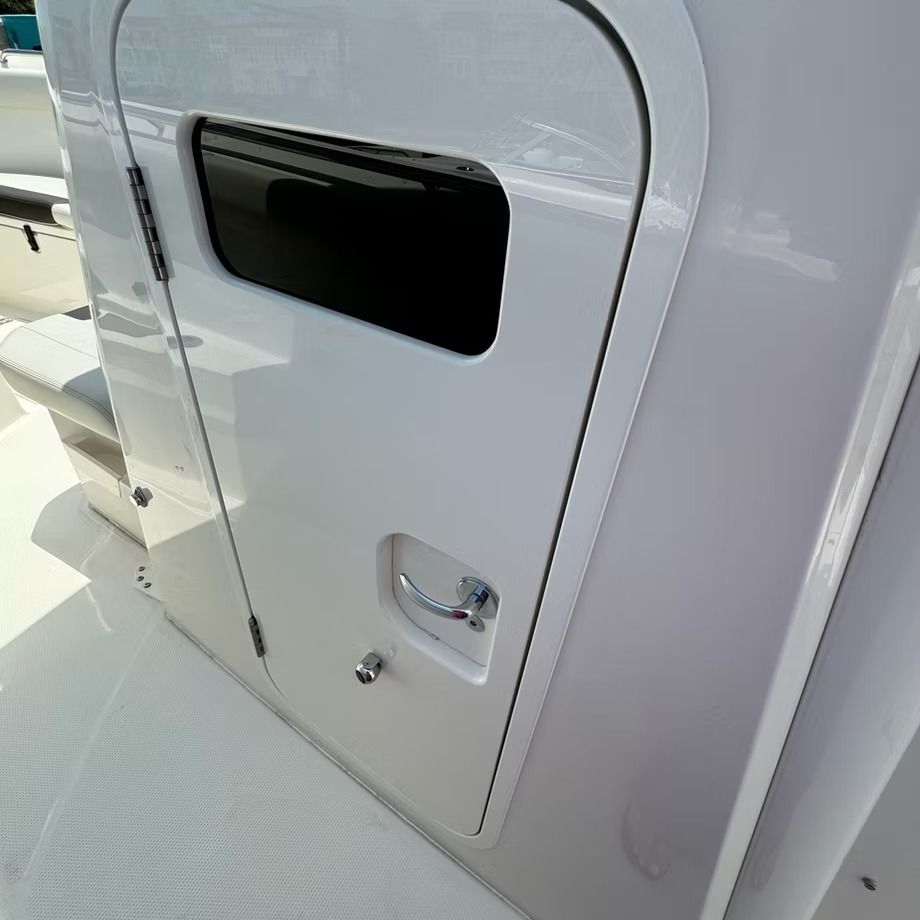 White boat door with a handle, window, and a lock.