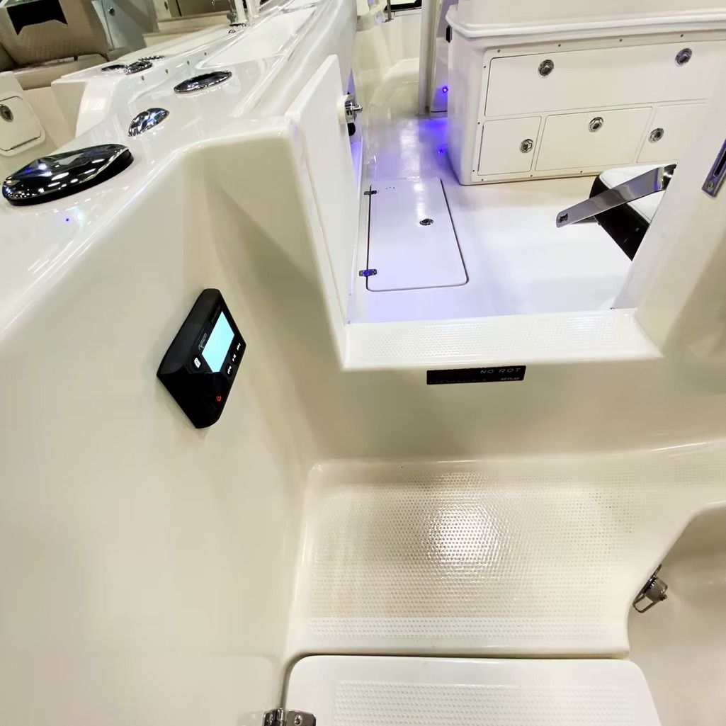 Boat interior with cream-colored surfaces, gauges, and recessed blue lights.