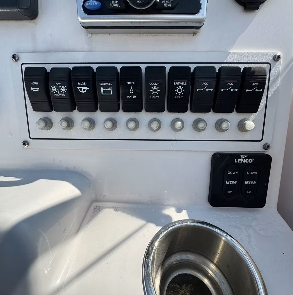 Boat dashboard with switch panel and cup holder.