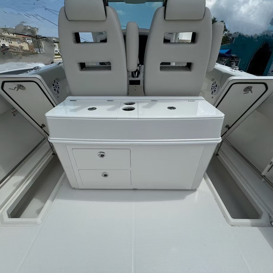 White boat interior with two seats, storage compartments, and center console.
