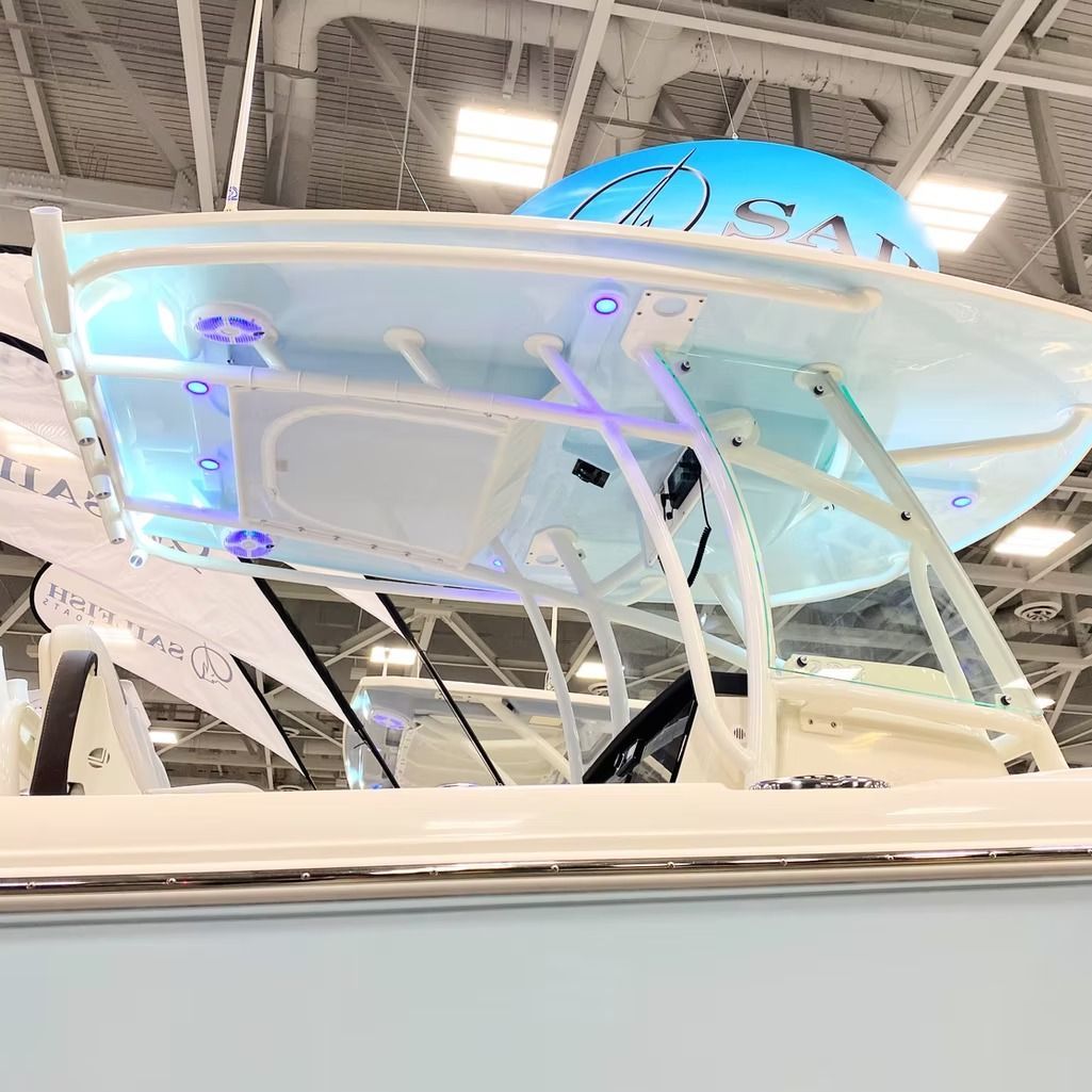 Boat with a white canopy and blue lighting.