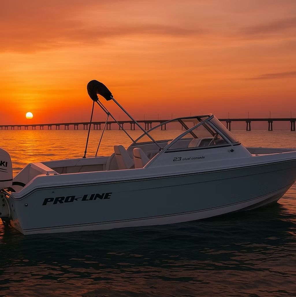 Boat on the water at sunset, with a pier in the distance.