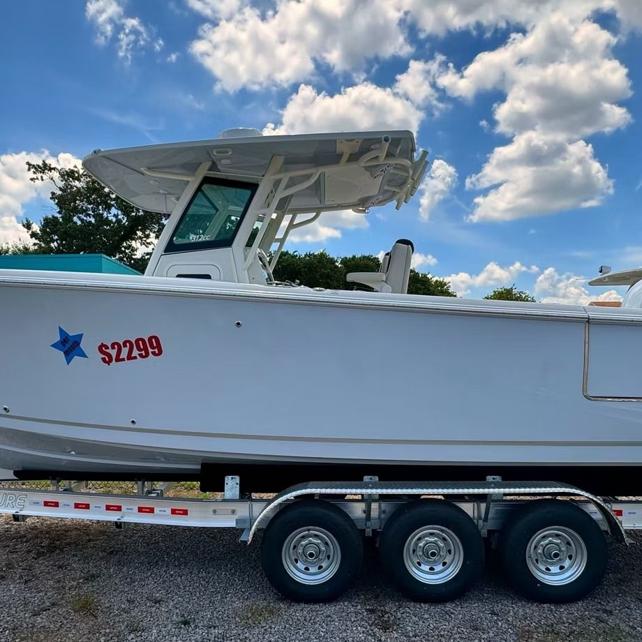 White boat on a trailer, with a blue star sticker and $22,299 text.