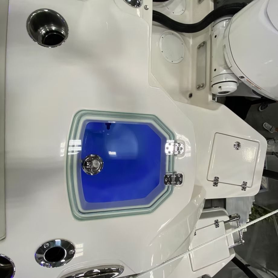 White boat interior with a blue-lit door, metal accents, and storage compartments.