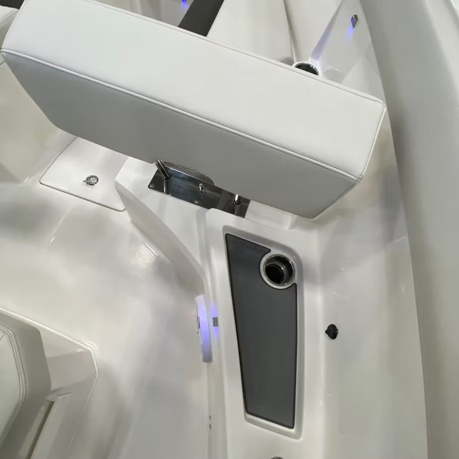 White boat interior with a seat, cup holder, and gray panel.