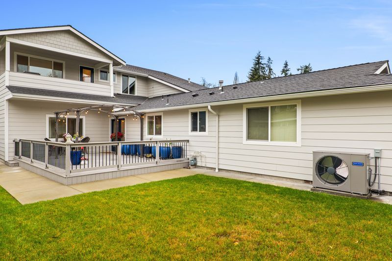 A large white house with a large lawn in front of it.