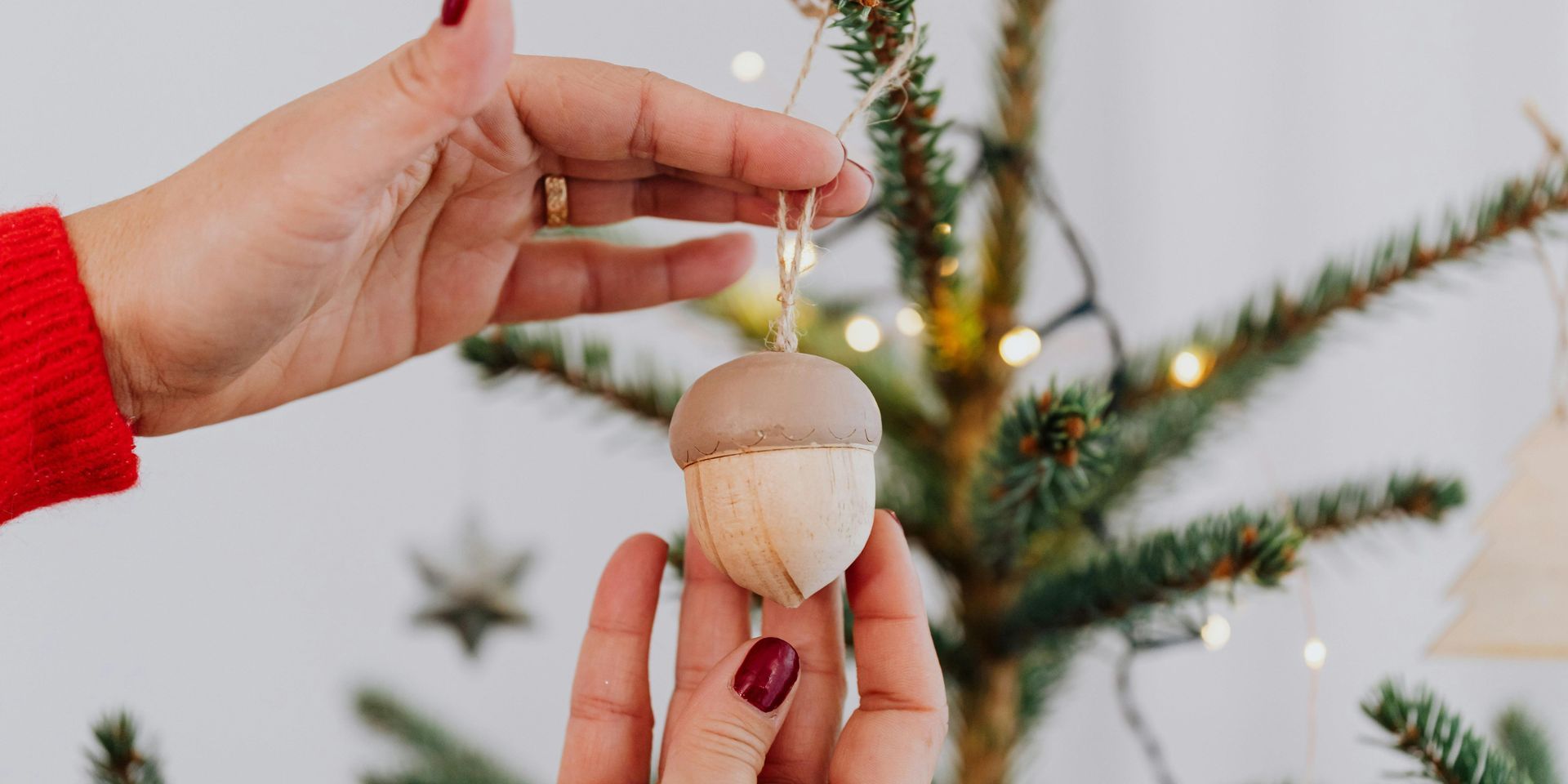 Cozy scene: feet in patterned socks warmed by a fireplace in a wooden-walled room.