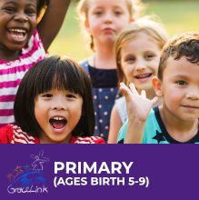 A group of children are standing next to each other and smiling.