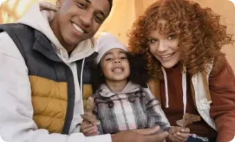 A man , woman and child are posing for a picture together.