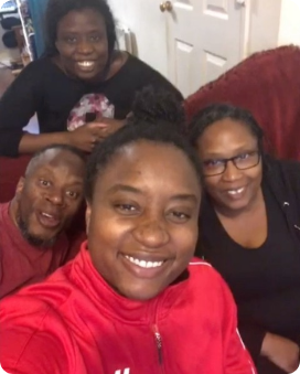 A group of people are posing for a picture and one of them is wearing a red jacket
