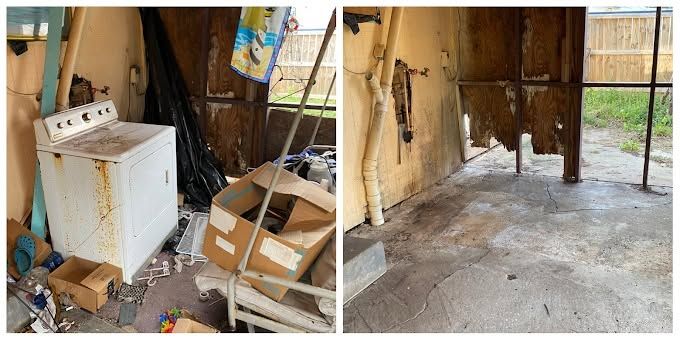 Moldy laundry room with damaged washer, cluttered boxes, and stained concrete floor.