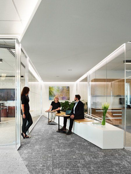 A man and a woman are sitting on a bench in a room.