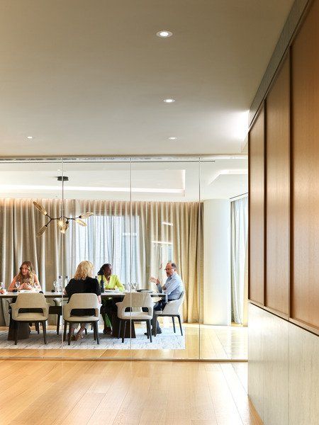 A group of people are sitting around a table in a room.