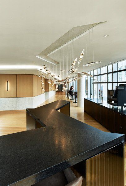 A large room with a black counter top and a lot of windows