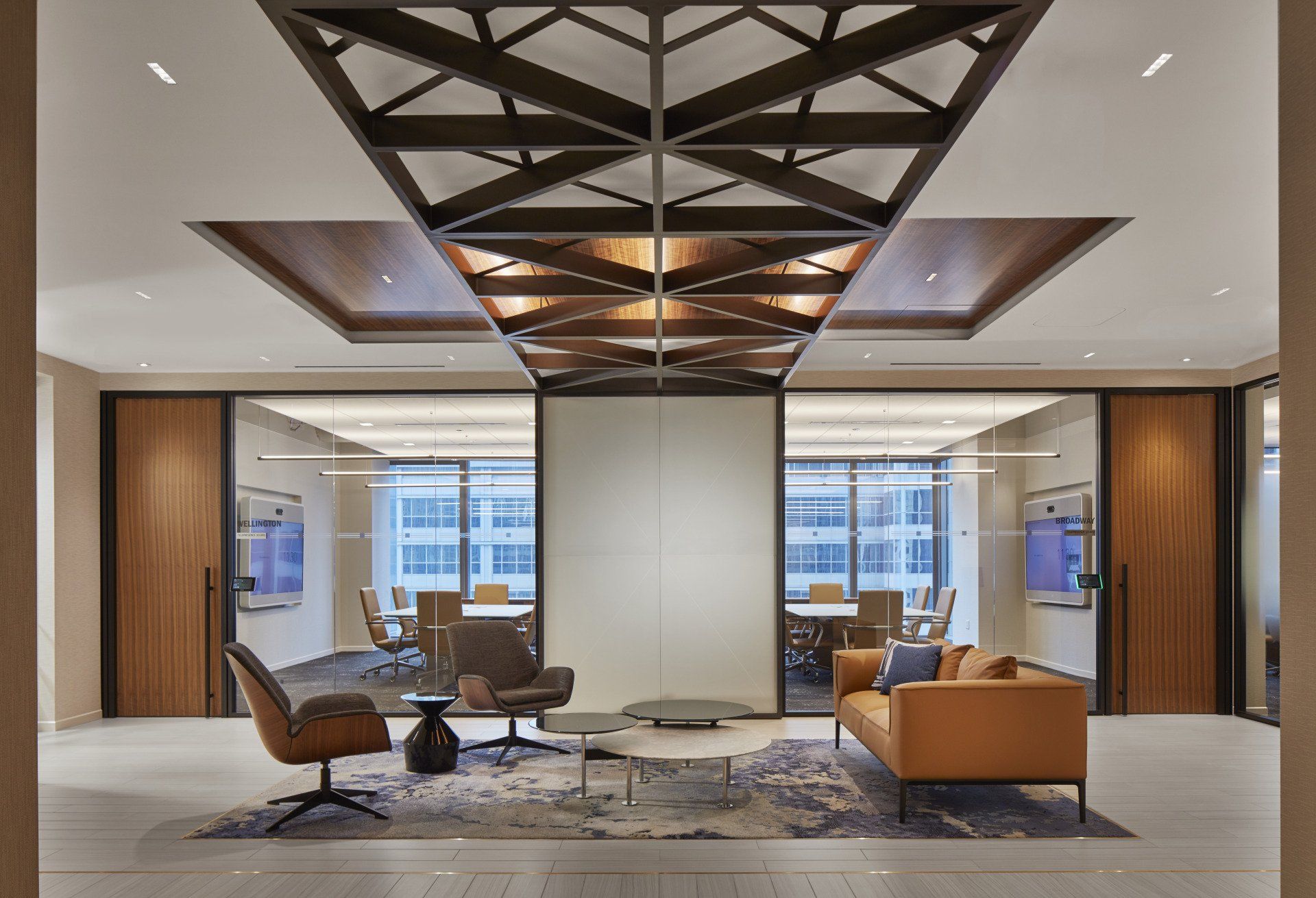 A living room with a couch , chairs , and a table.