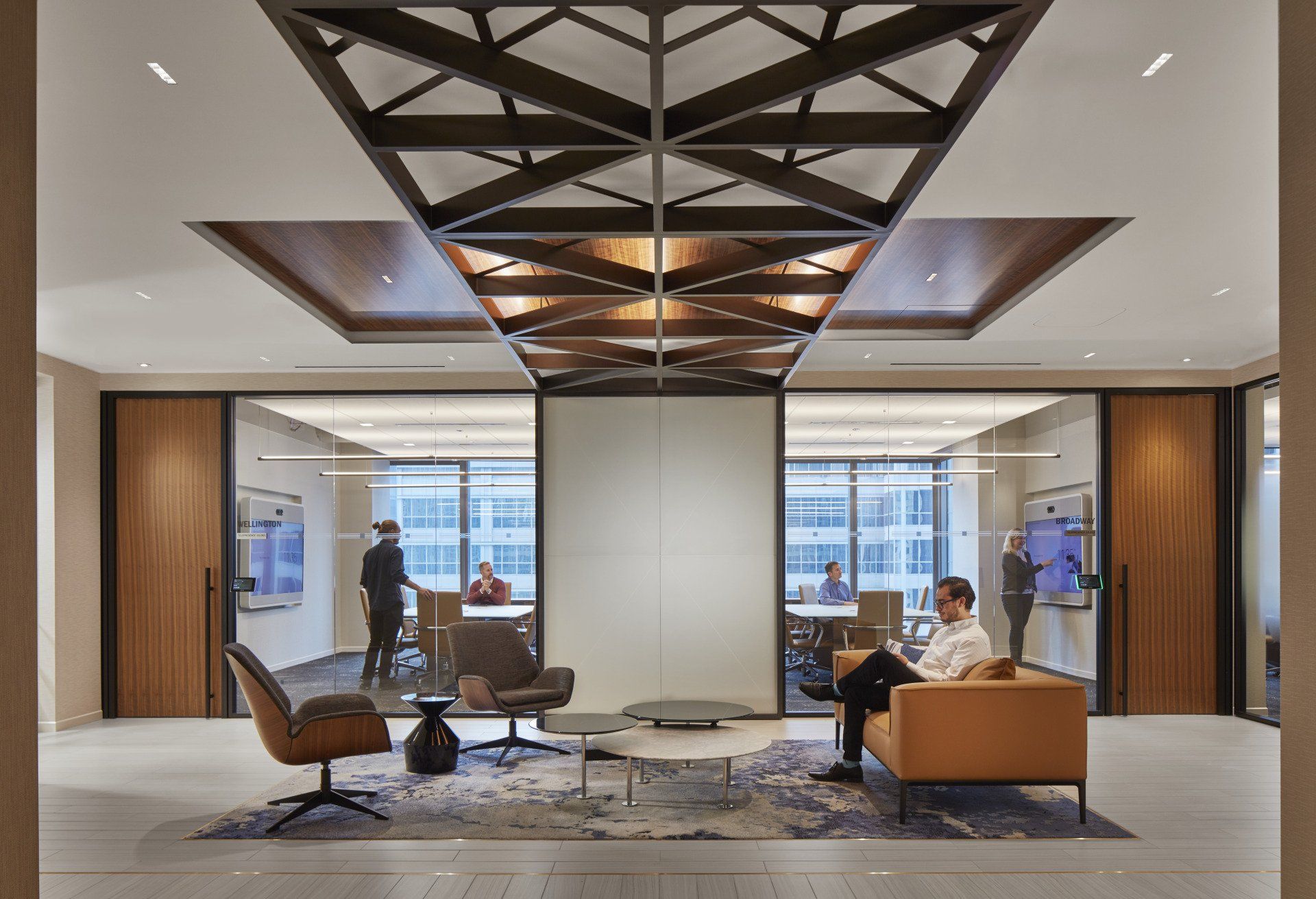 A man is sitting on a couch in a living room.