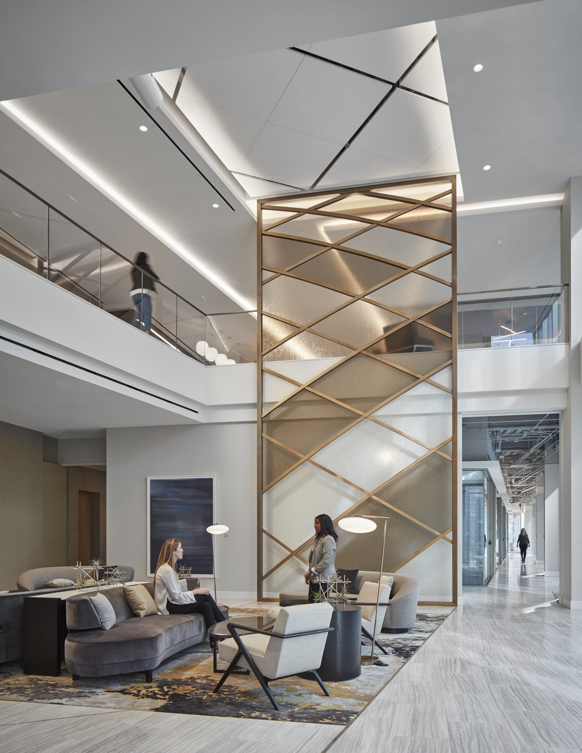 A woman is sitting on a couch in a living room