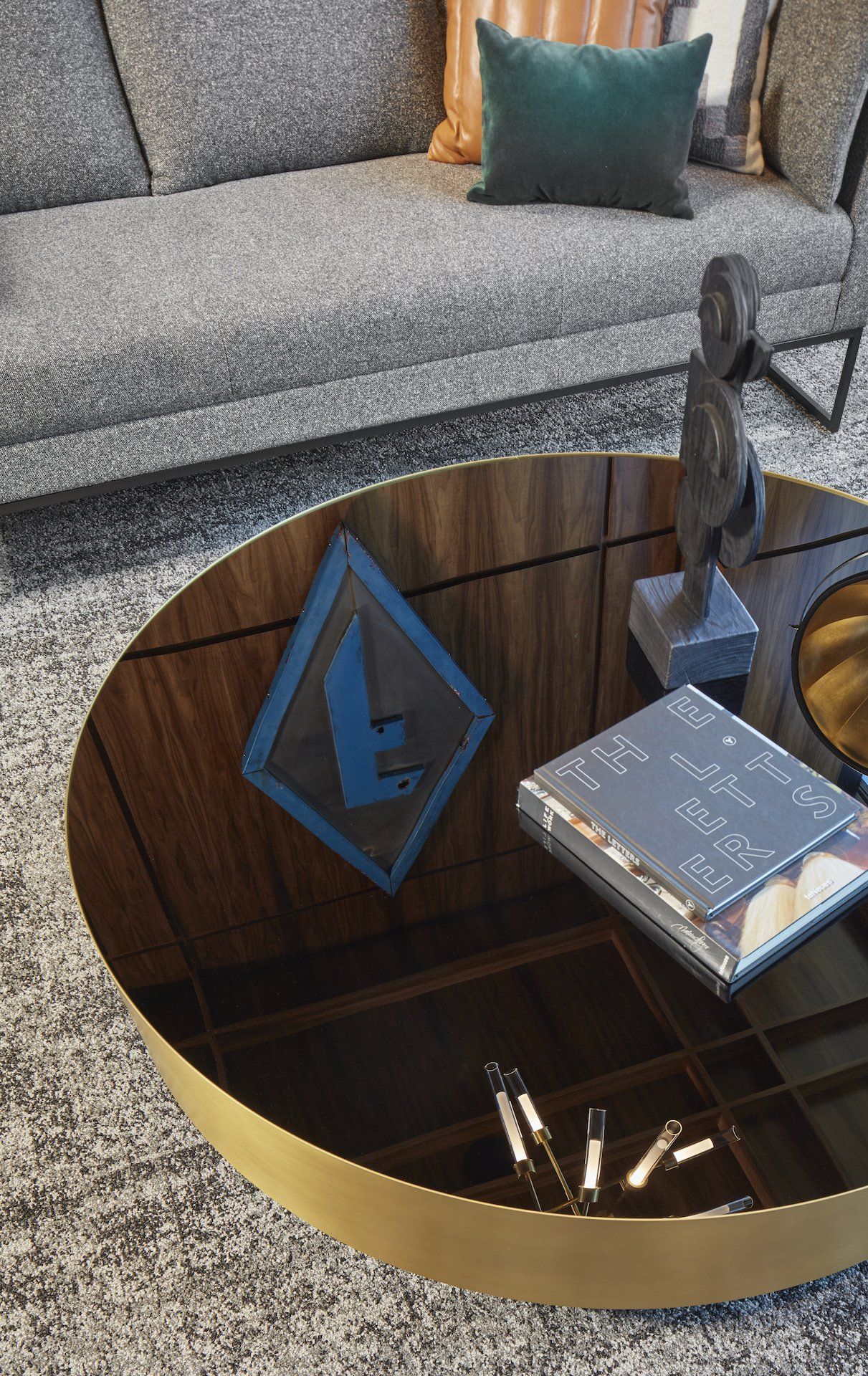 A living room with a round coffee table and a couch.