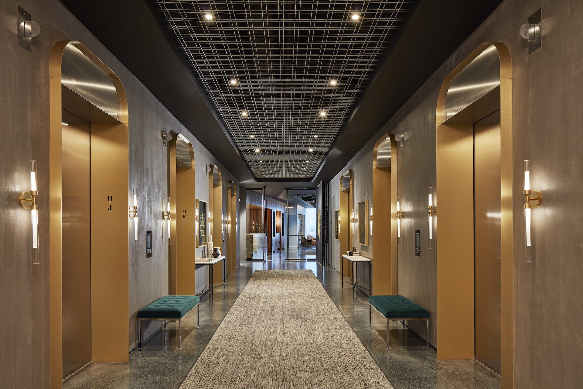 A long hallway with elevators in a building.