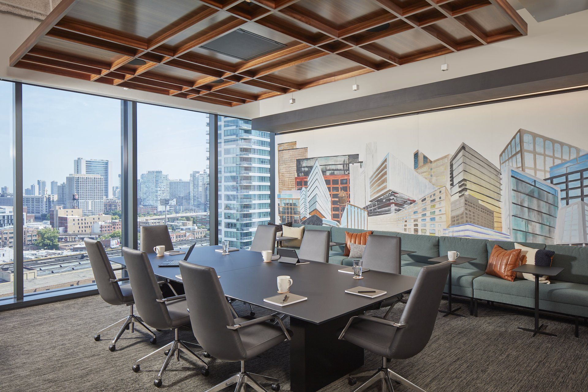 A conference room with a large table and chairs and a couch.
