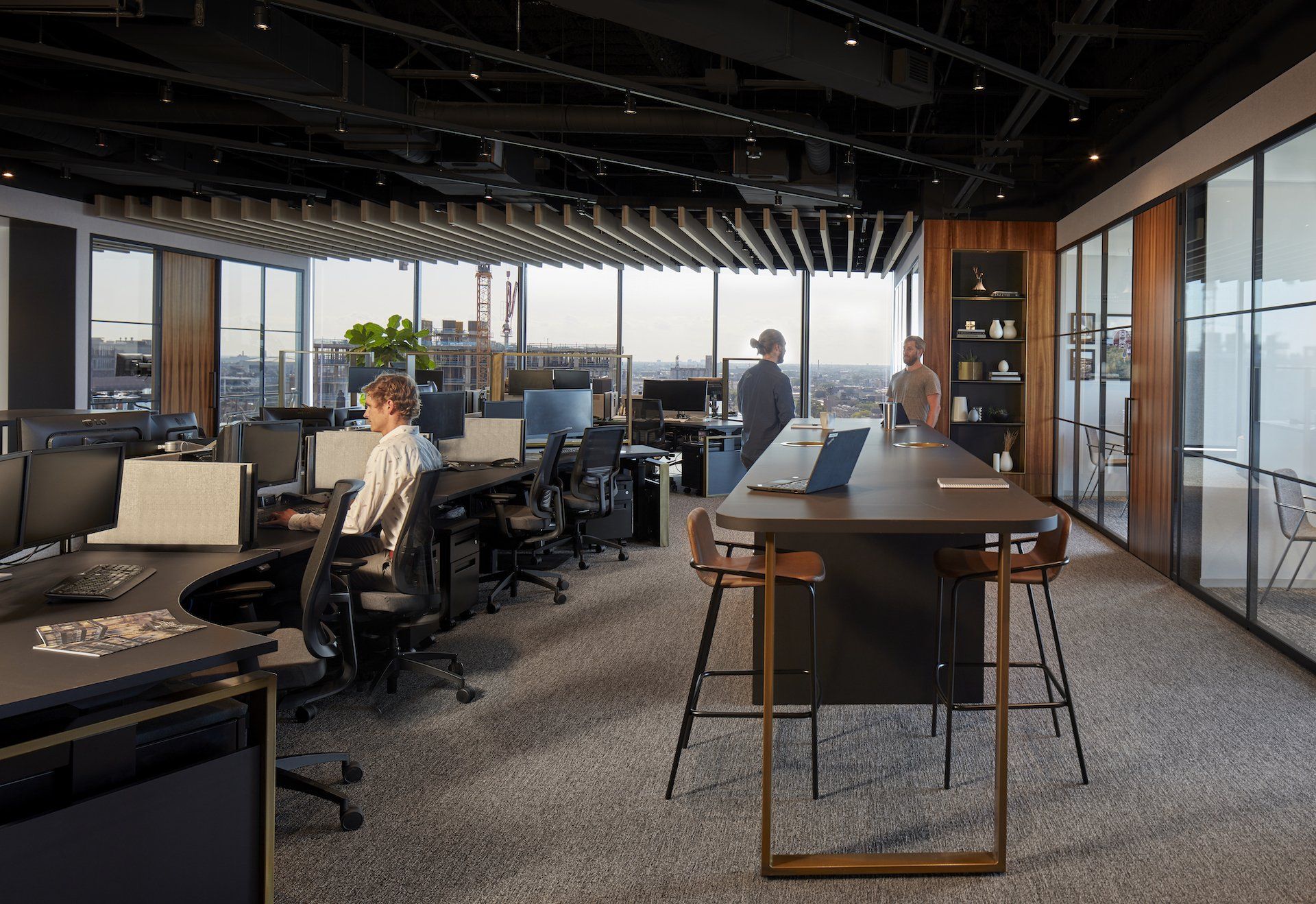 A man is sitting at a desk in an office.