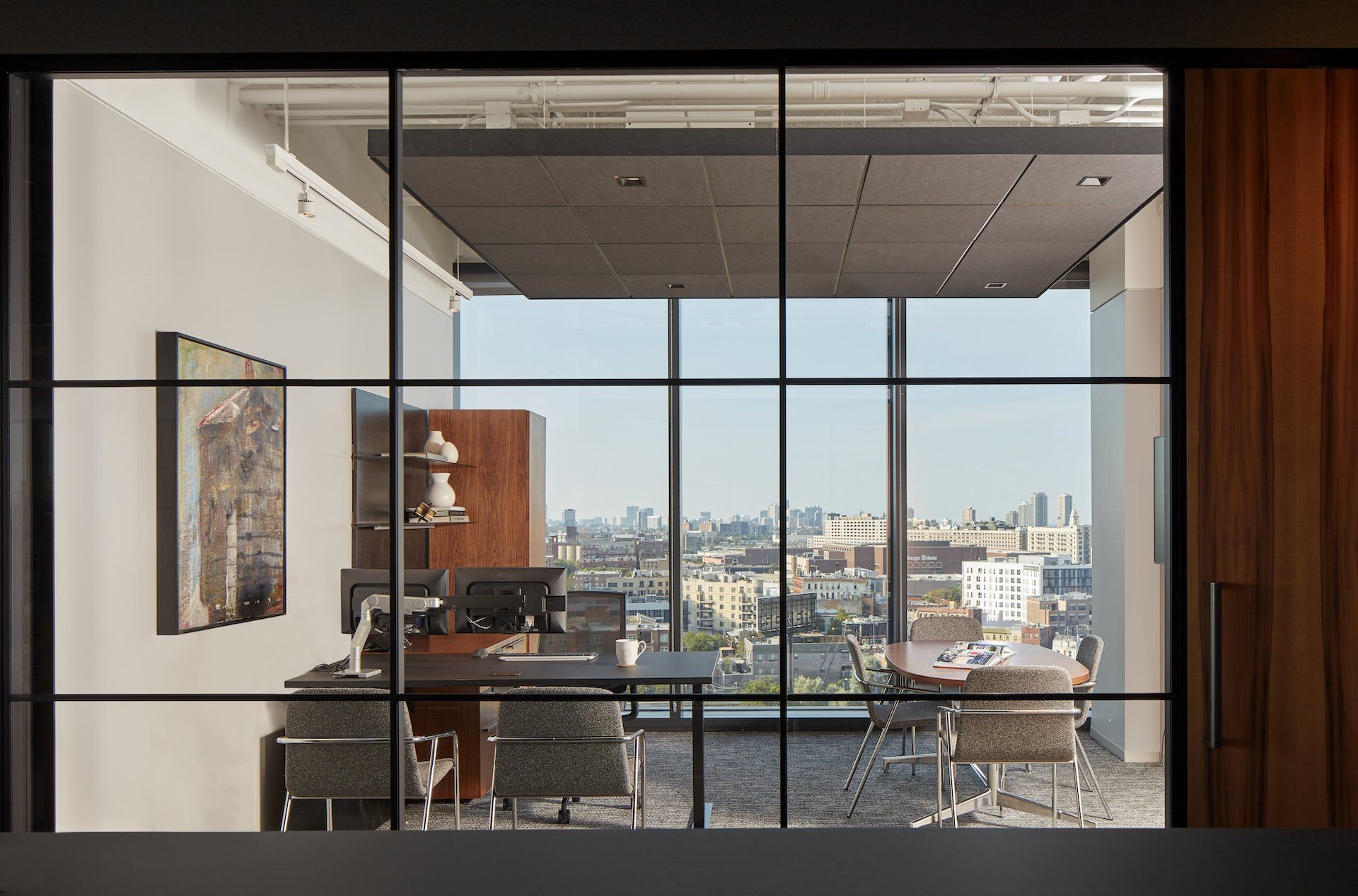 A room with a lot of windows and a table and chairs