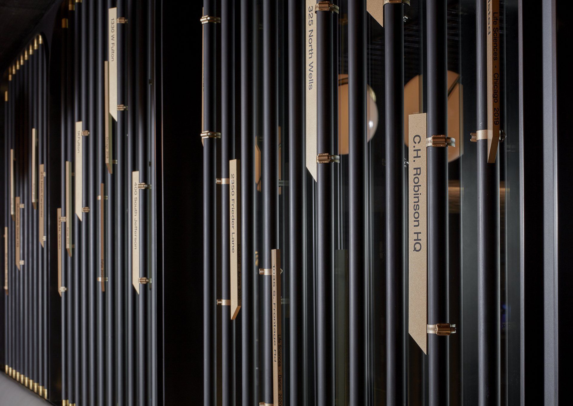 A row of black bars with wooden handles on them.