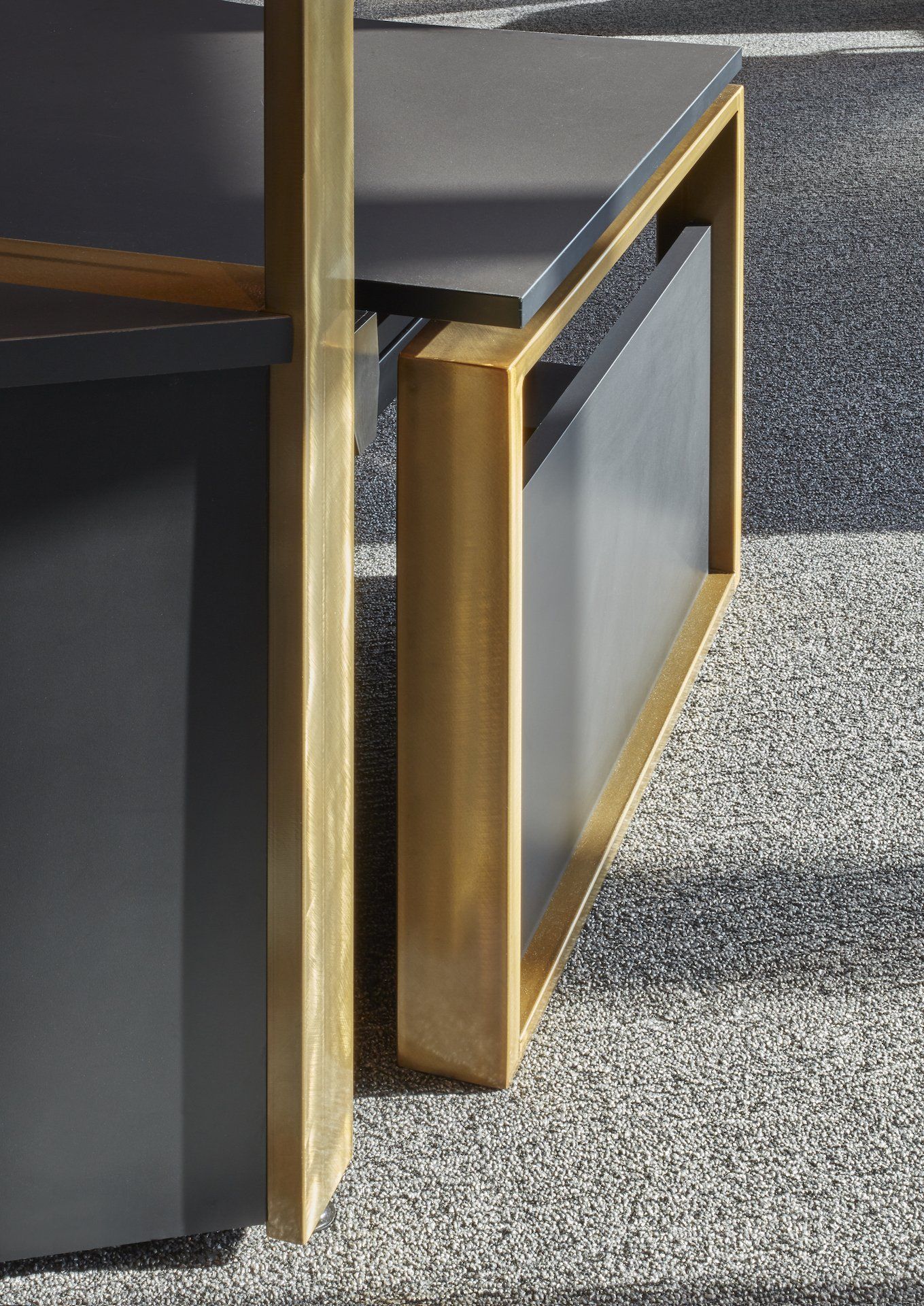 A close up of a wooden bench with a magazine holder underneath it.