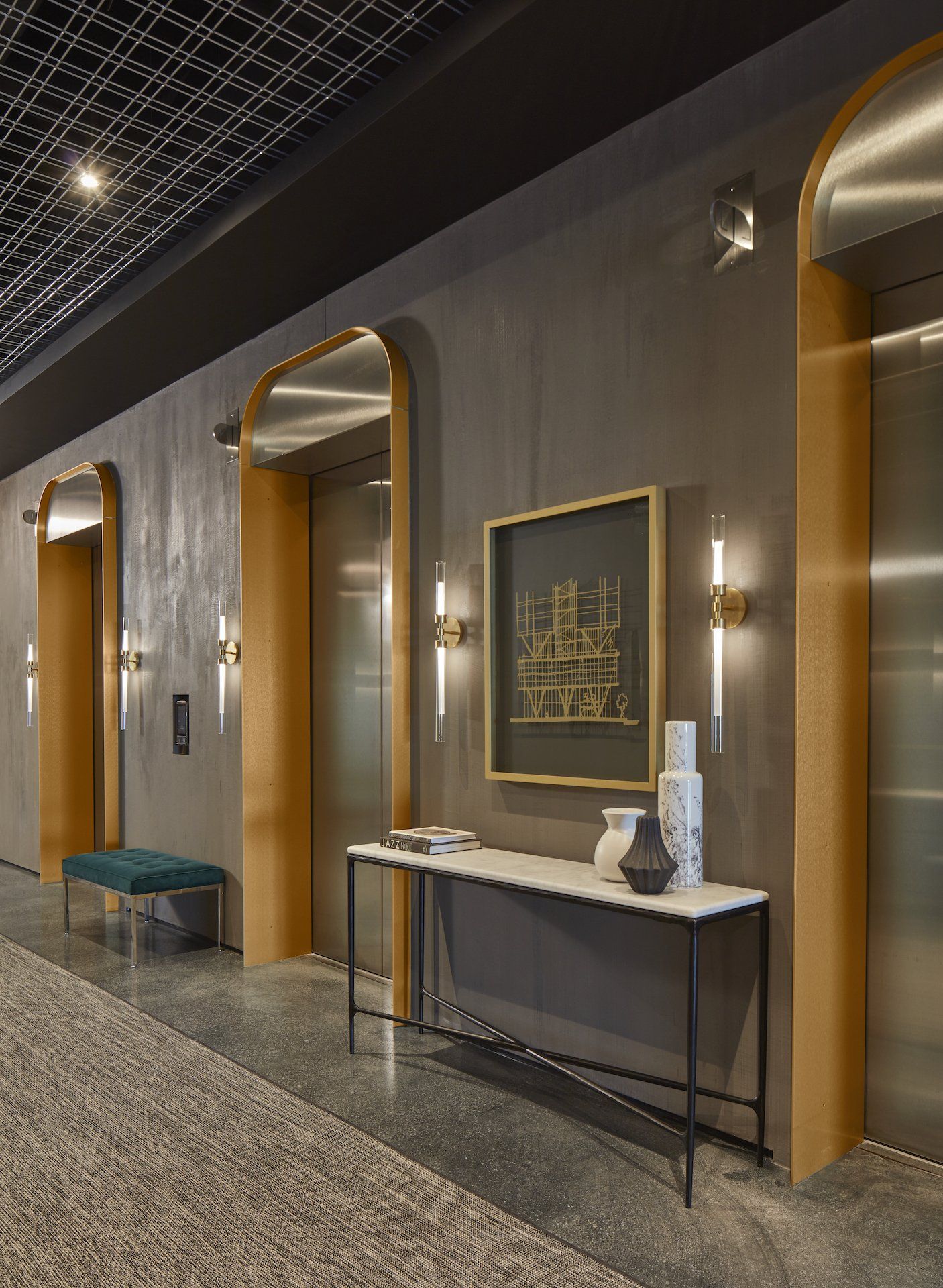 A hallway with a table and a picture on the wall.