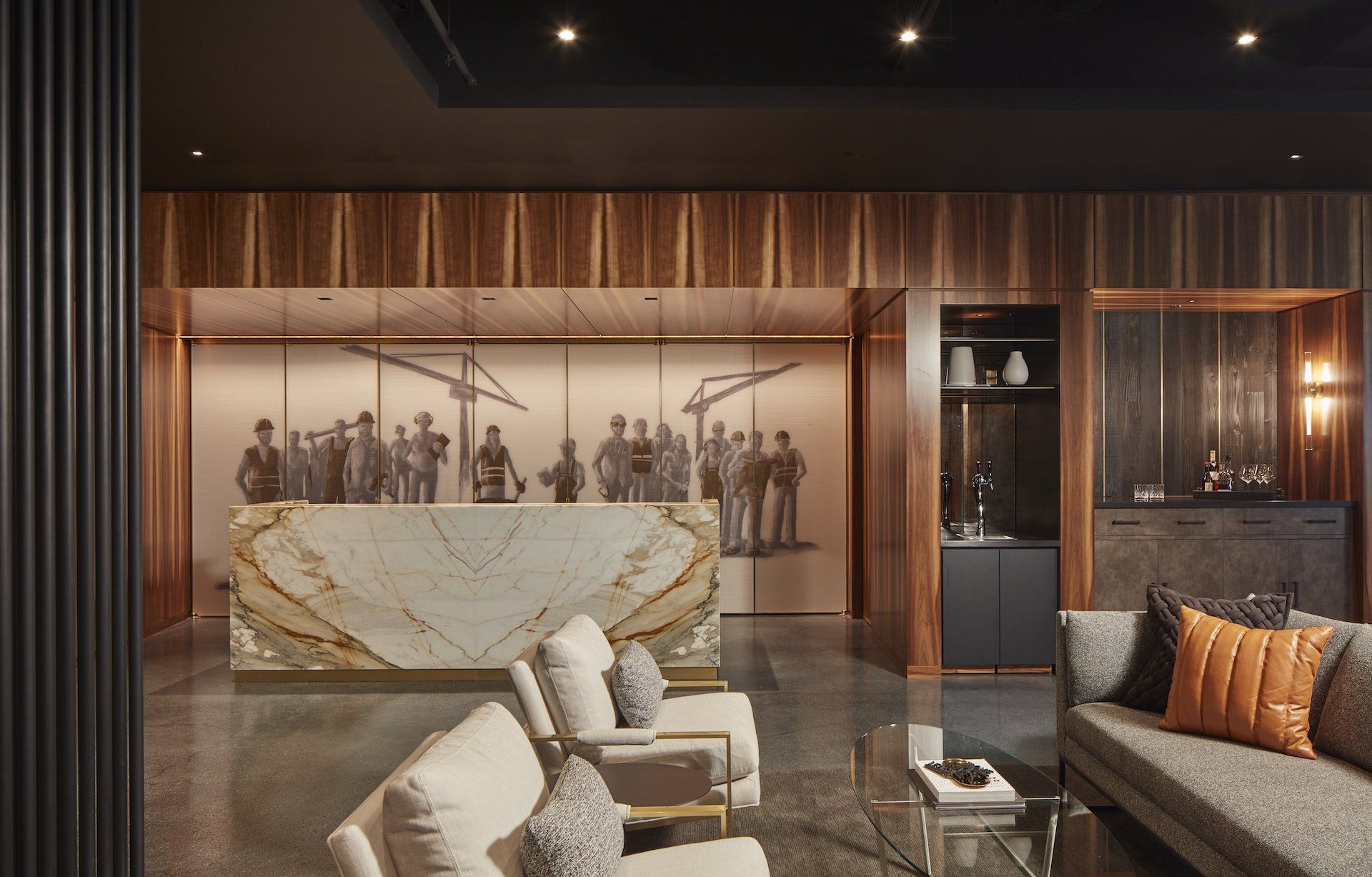 A living room with a couch , chairs , and a counter.