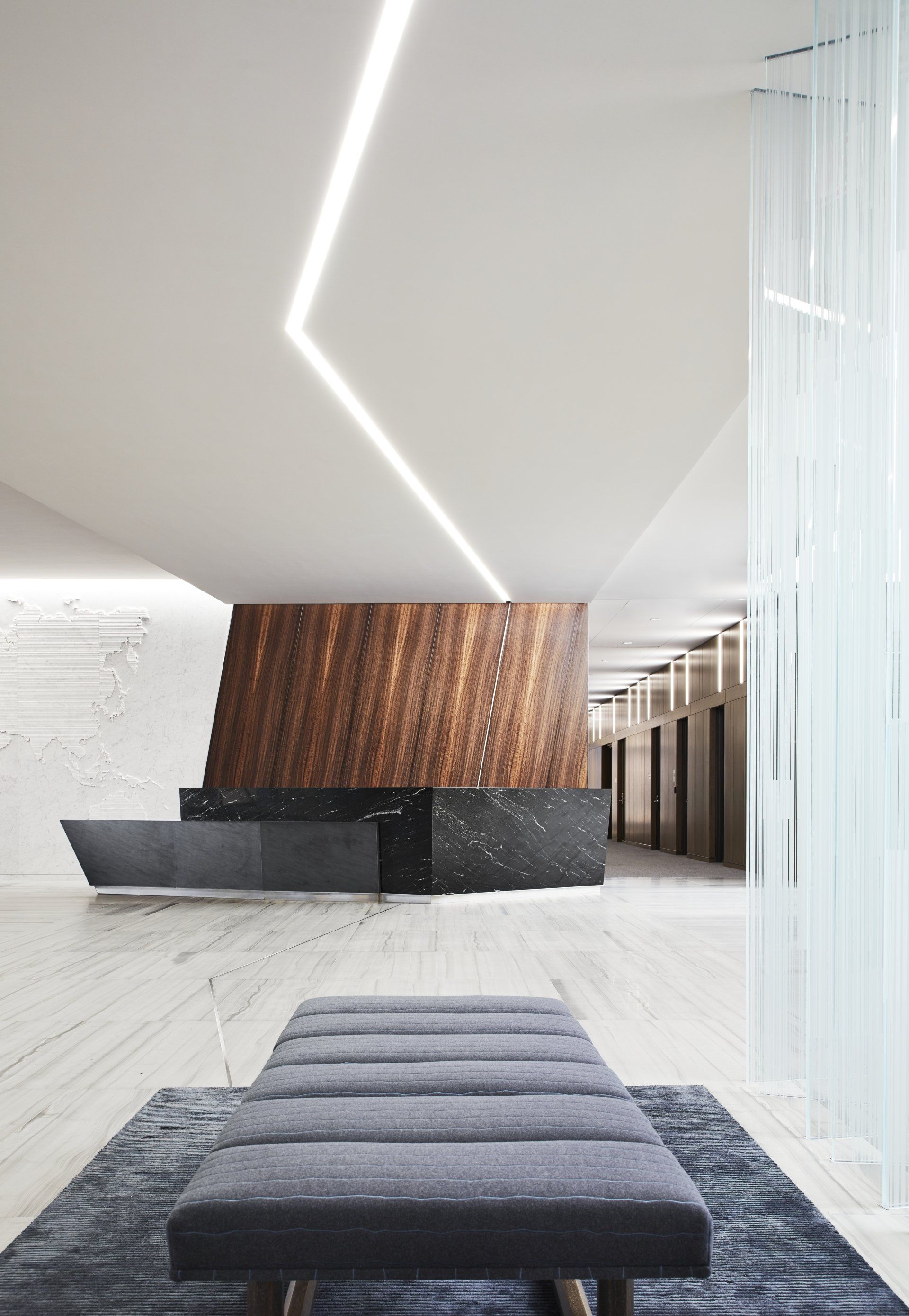 A lobby with a bench and a reception desk
