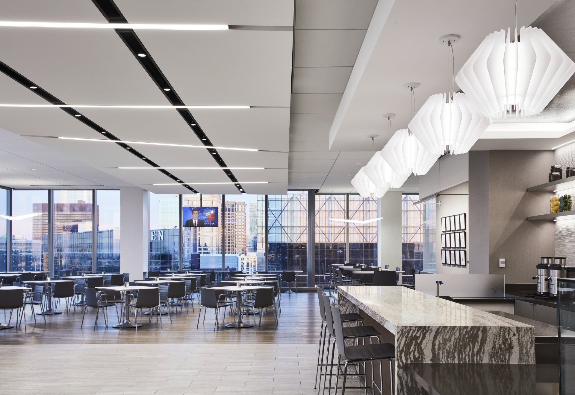 A large dining room with tables and chairs and a bar