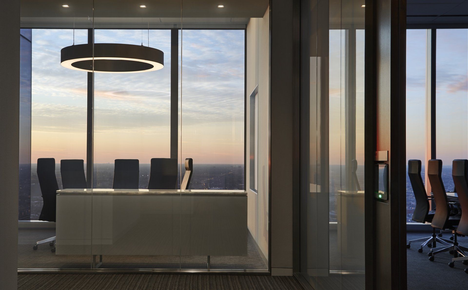 An artist 's impression of a conference room with a view of the city.