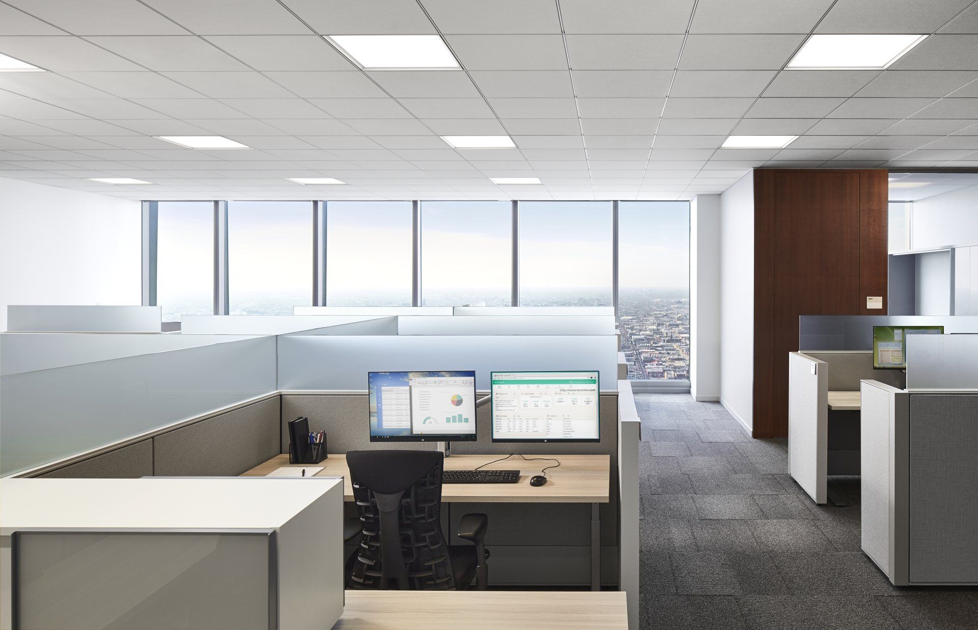 An artist 's impression of an office with cubicles and computers