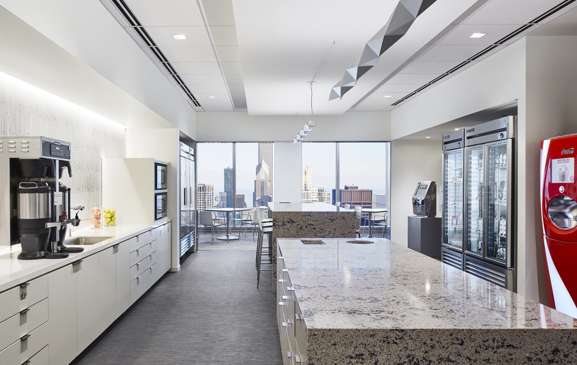 A kitchen with a large counter and a red vending machine