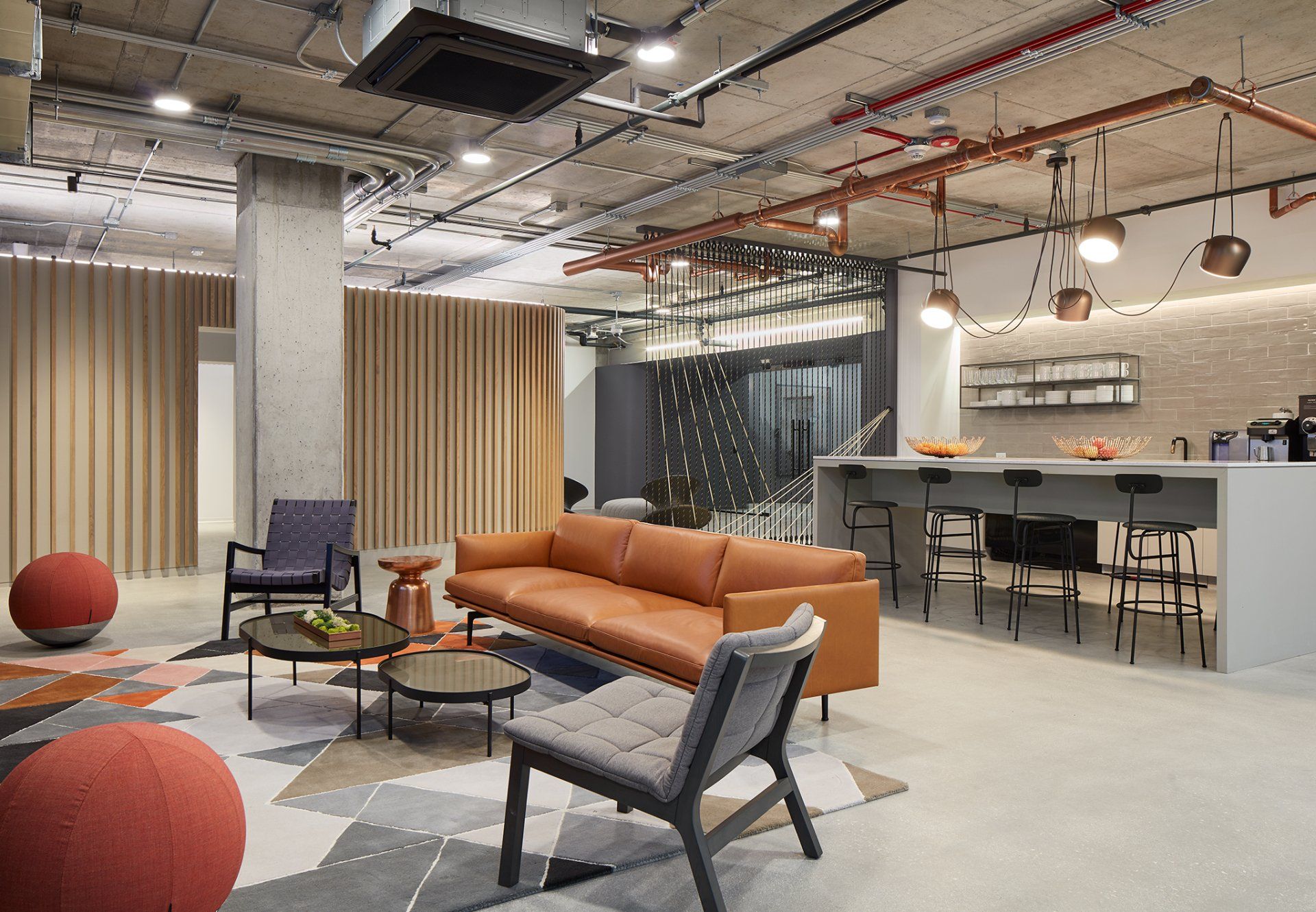 A living room with a couch , chairs , tables and curtains.