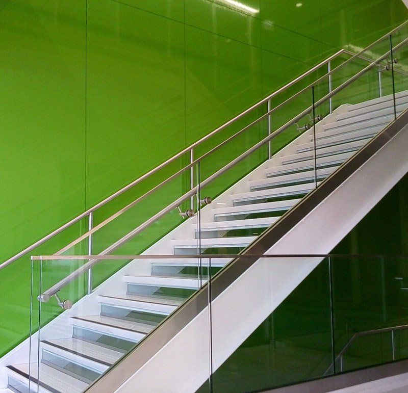 A staircase with a green wall behind it