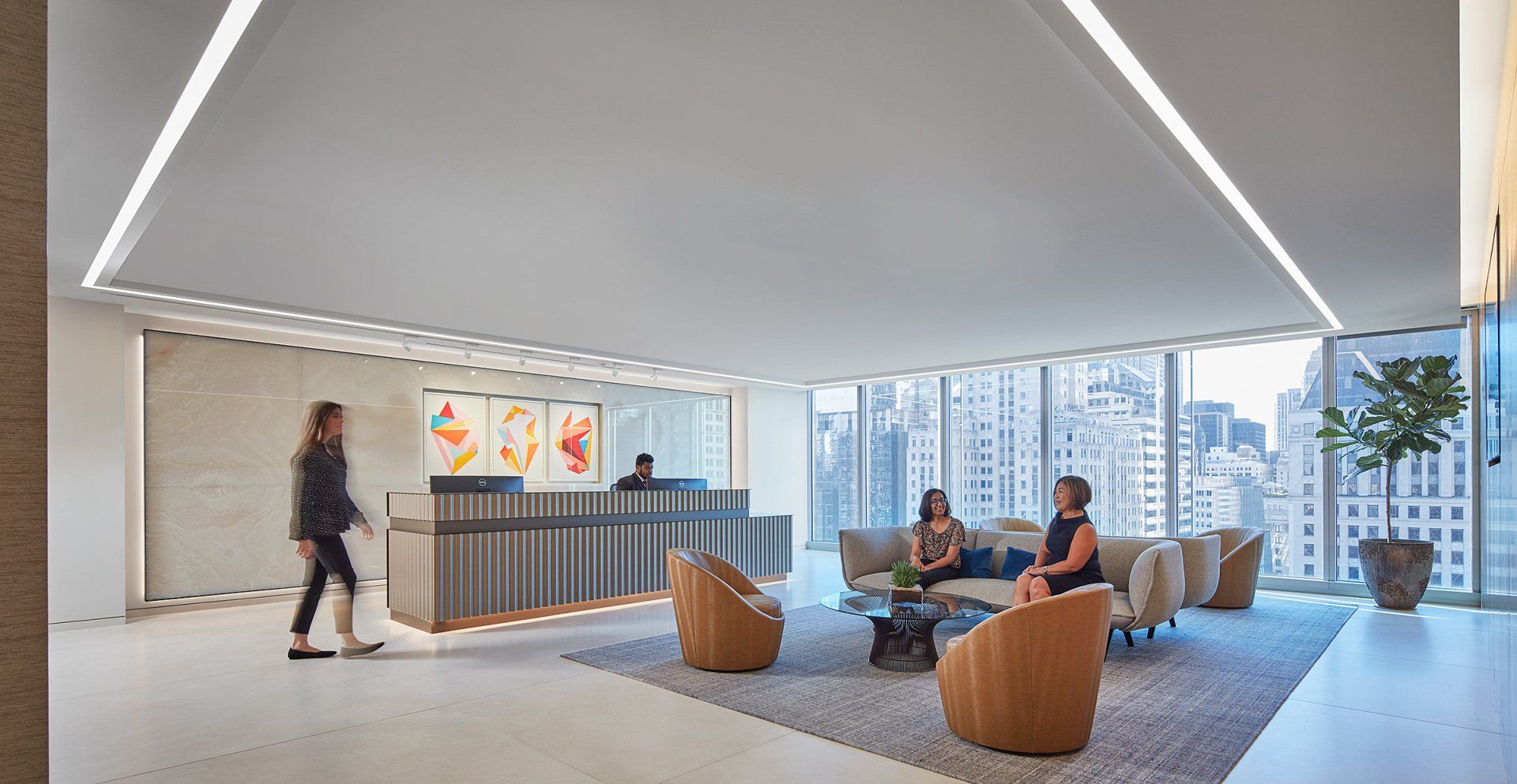 A group of people are sitting at a table in a lobby.